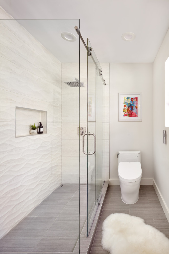 Design ideas for a mid-sized transitional bathroom in San Francisco with flat-panel cabinets, white cabinets, a corner shower, a one-piece toilet, beige tile, porcelain tile, grey walls, porcelain floors, an undermount sink, quartzite benchtops, grey floor, a hinged shower door, white benchtops, a niche, a double vanity and a floating vanity.