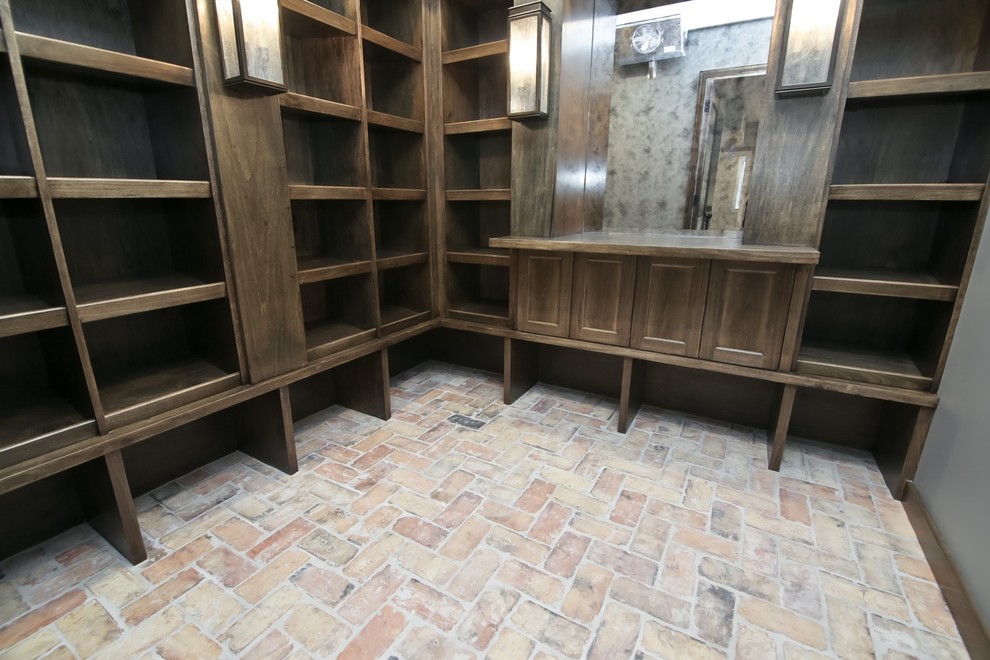 This is an example of a mid-sized transitional wine cellar in Chicago with brick floors, multi-coloured floor and storage racks.