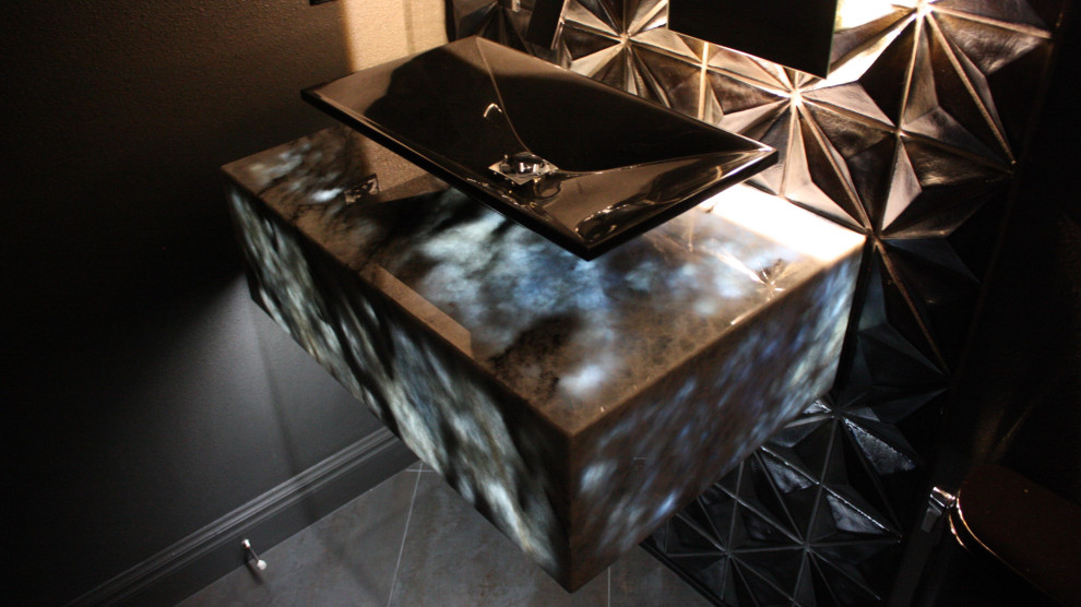 Powder room - small modern black tile powder room idea in Tampa with black cabinets, a one-piece toilet, black walls, a vessel sink, white countertops and a floating vanity