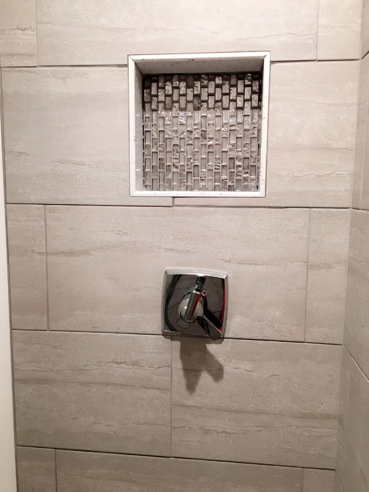 Alcove shower - mid-sized transitional beige tile, brown tile and porcelain tile porcelain tile and beige floor alcove shower idea in Detroit with a two-piece toilet and beige walls