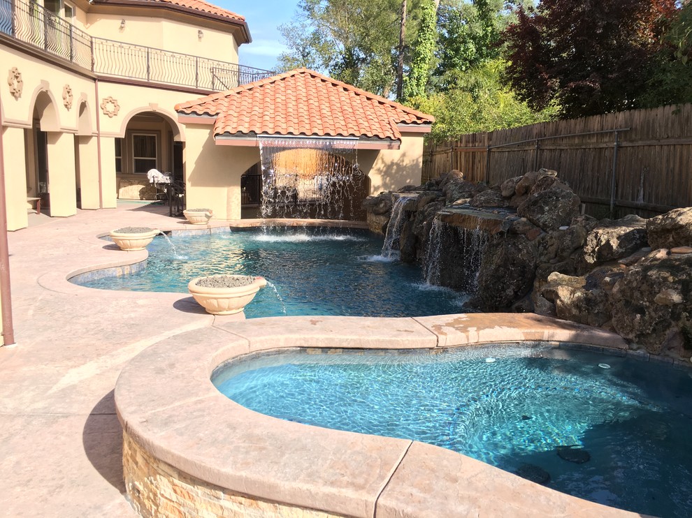 Medium sized world-inspired back natural swimming pool in Sacramento with a pool house and stamped concrete.