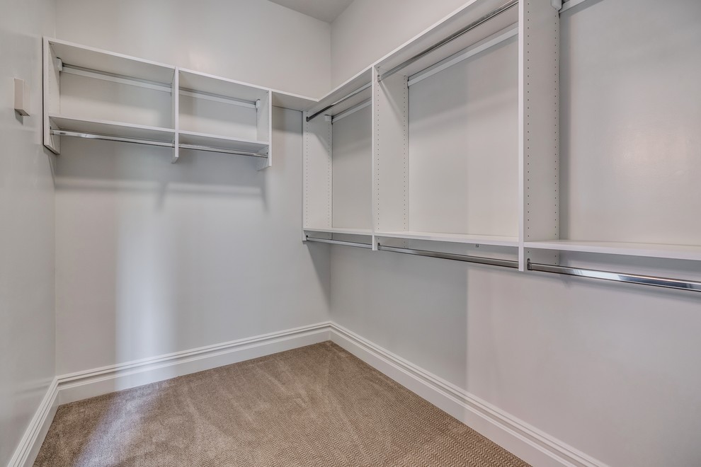 Example of a transitional gender-neutral carpeted and gray floor walk-in closet design