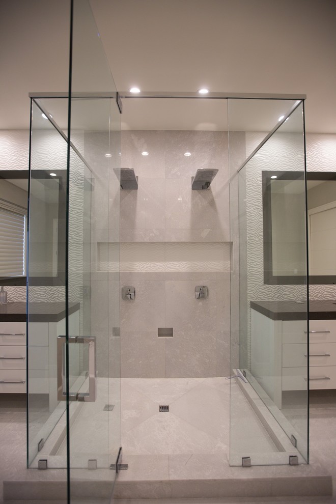 Photo of a large modern master bathroom in Miami with flat-panel cabinets, white cabinets, a corner shower, white tile, ceramic tile, white walls, an undermount sink, solid surface benchtops, beige floor, a hinged shower door and brown benchtops.