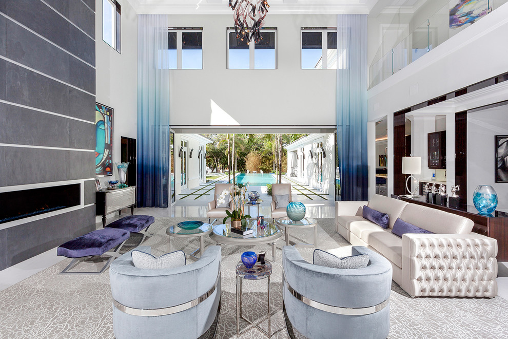 Inspiration for an expansive contemporary enclosed living room in Miami with white walls, porcelain floors, a ribbon fireplace, a metal fireplace surround, no tv and white floor.
