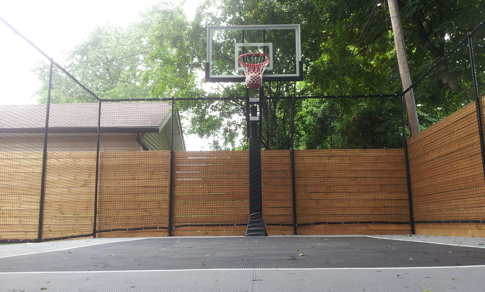 Photo of a small contemporary backyard shaded outdoor sport court for summer in Toronto with with outdoor playset and concrete pavers.