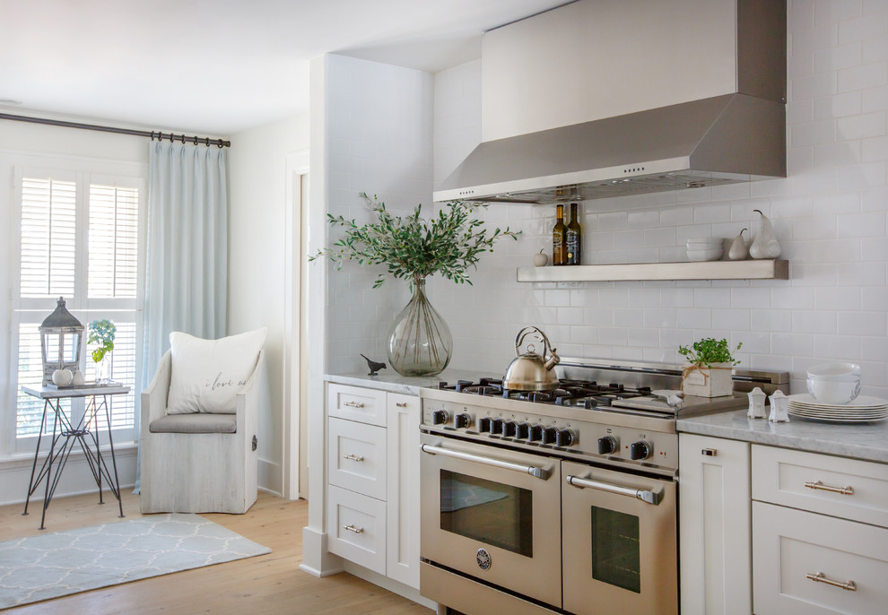 Inspiration for a transitional u-shaped kitchen remodel in Jacksonville with shaker cabinets, white cabinets, marble countertops, subway tile backsplash and stainless steel appliances