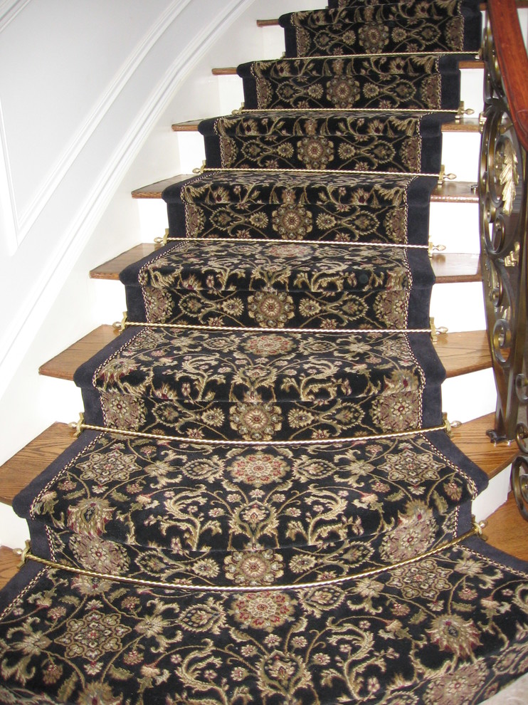 This is an example of a mid-sized traditional wood curved staircase in New York with painted wood risers.