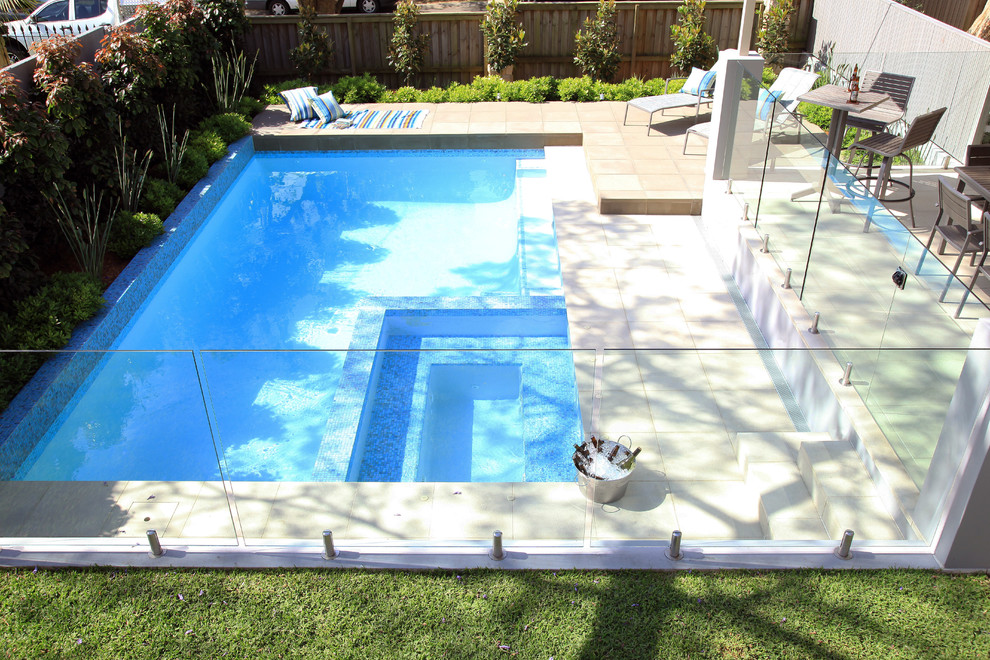 Design ideas for a mid-sized contemporary backyard rectangular lap pool in Sydney with a hot tub.