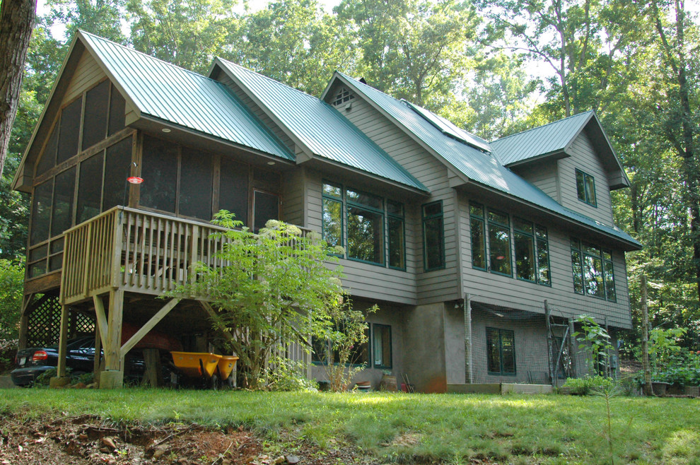 This is an example of a large contemporary three-storey brown house exterior in Raleigh with a gable roof and wood siding.