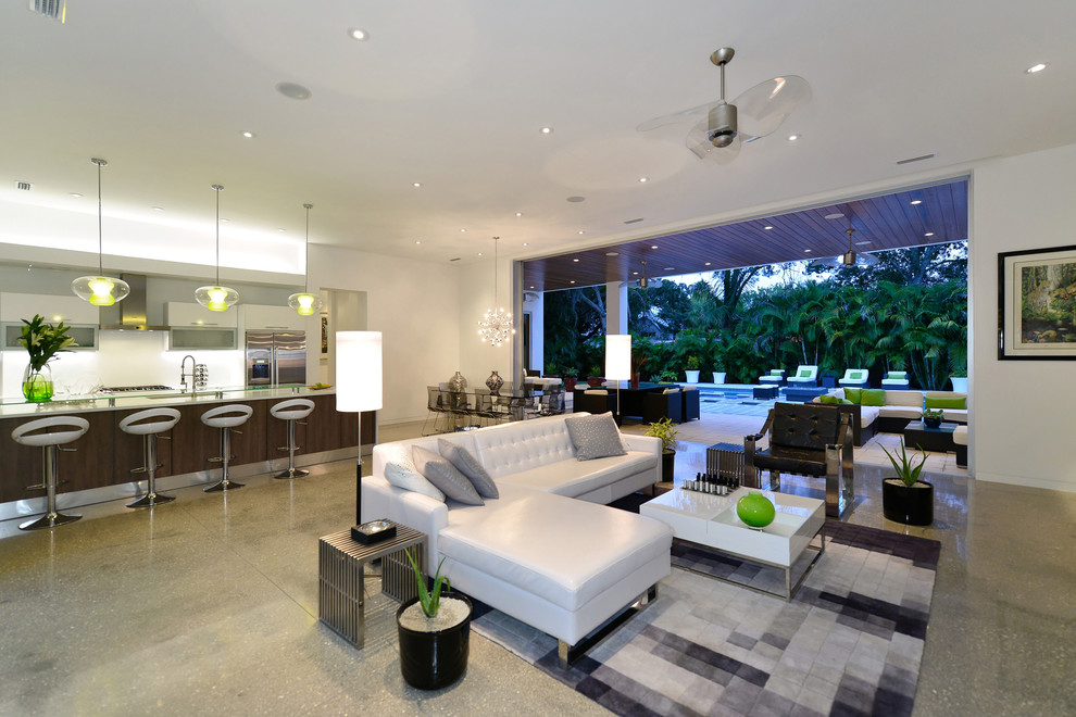 Contemporary formal open concept living room in Tampa with white walls and concrete floors.