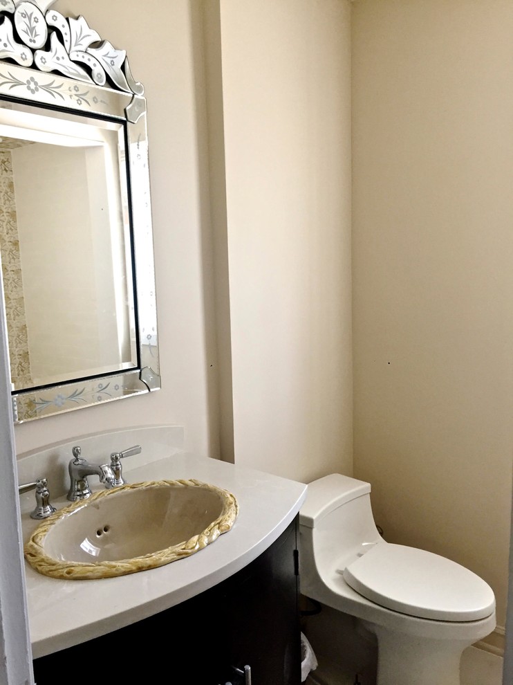 Example of a mid-sized transitional 3/4 porcelain tile and beige floor bathroom design in Chicago with flat-panel cabinets, black cabinets, a two-piece toilet, beige walls, a drop-in sink and quartz countertops