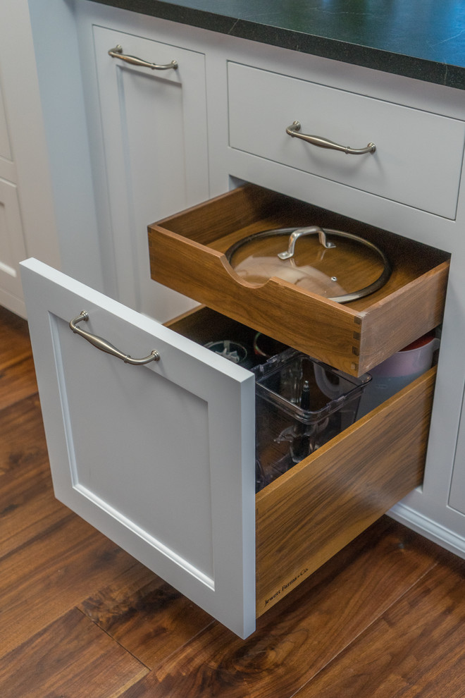 Enclosed kitchen - mid-sized transitional l-shaped dark wood floor and brown floor enclosed kitchen idea in Boston with an integrated sink, recessed-panel cabinets, white cabinets, soapstone countertops, multicolored backsplash, porcelain backsplash, stainless steel appliances and an island