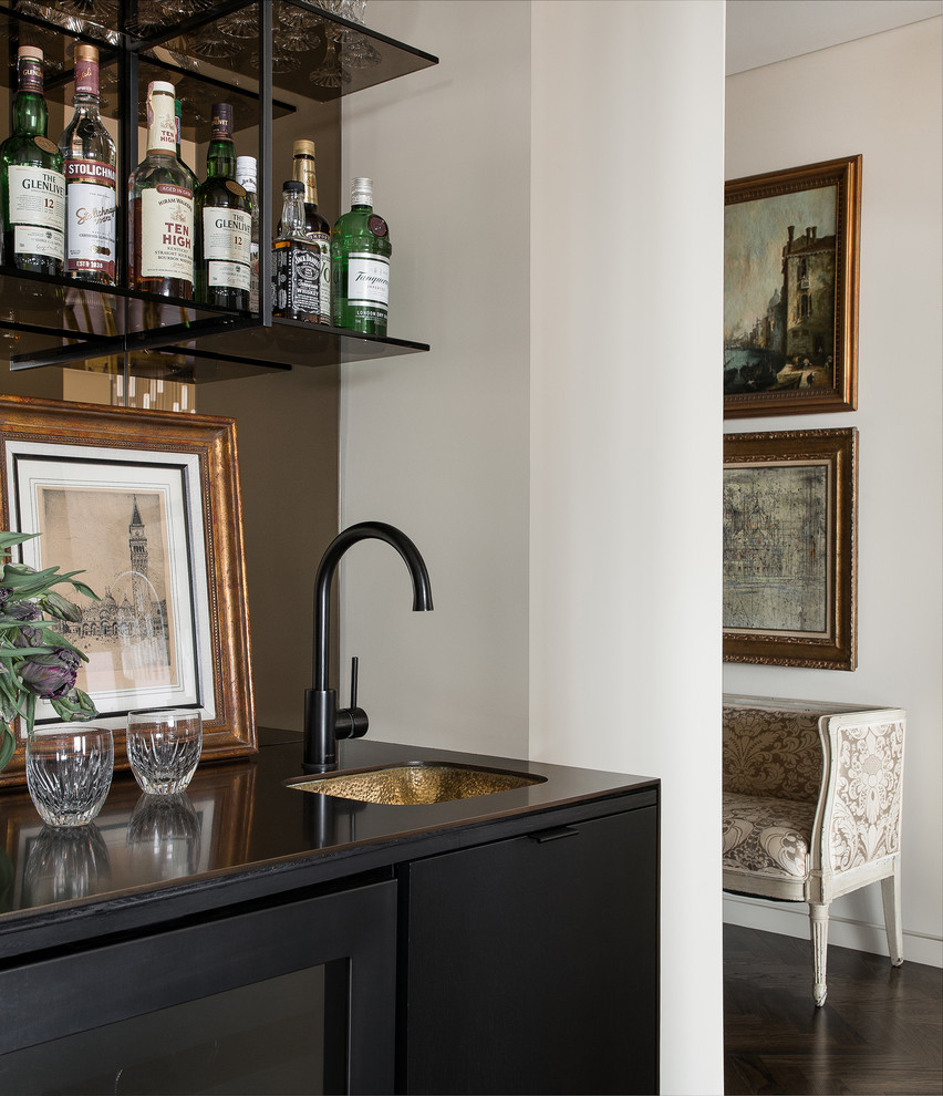 Small contemporary single-wall wet bar in Seattle with an undermount sink, mirror splashback, flat-panel cabinets, black cabinets, dark hardwood floors and black benchtop.