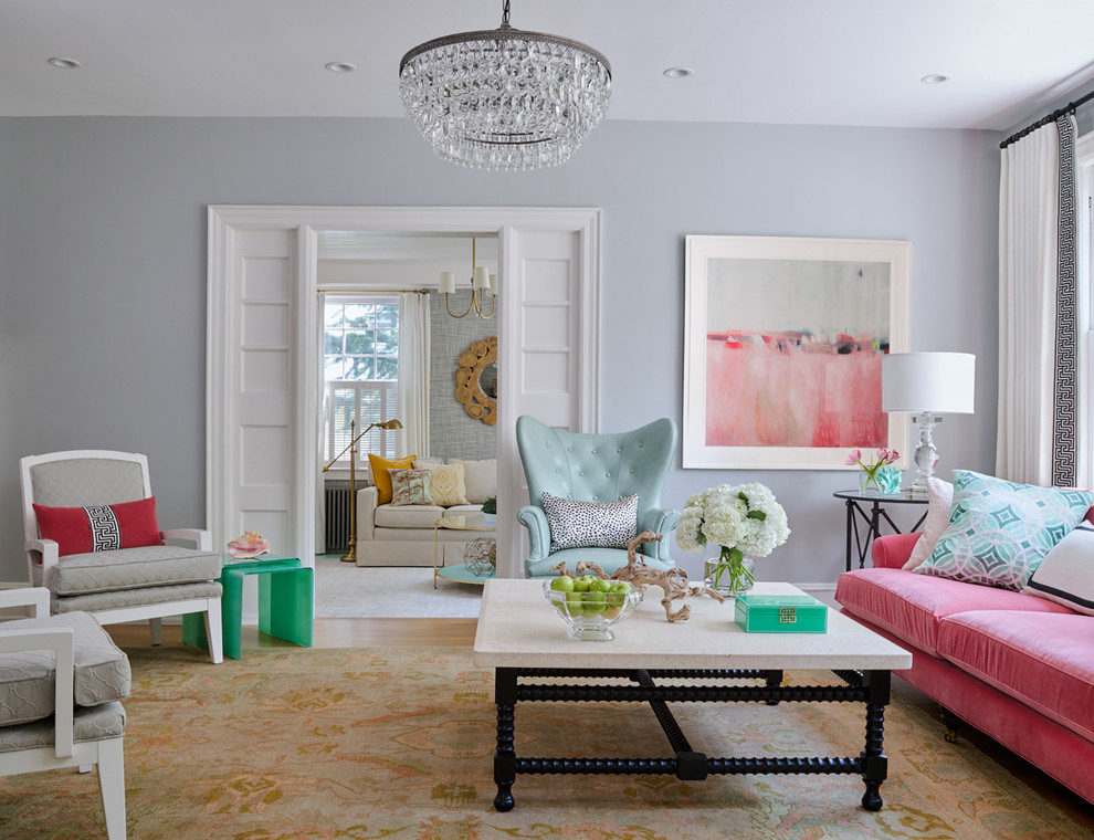 Eclectic living room in Philadelphia with grey walls and medium hardwood floors.