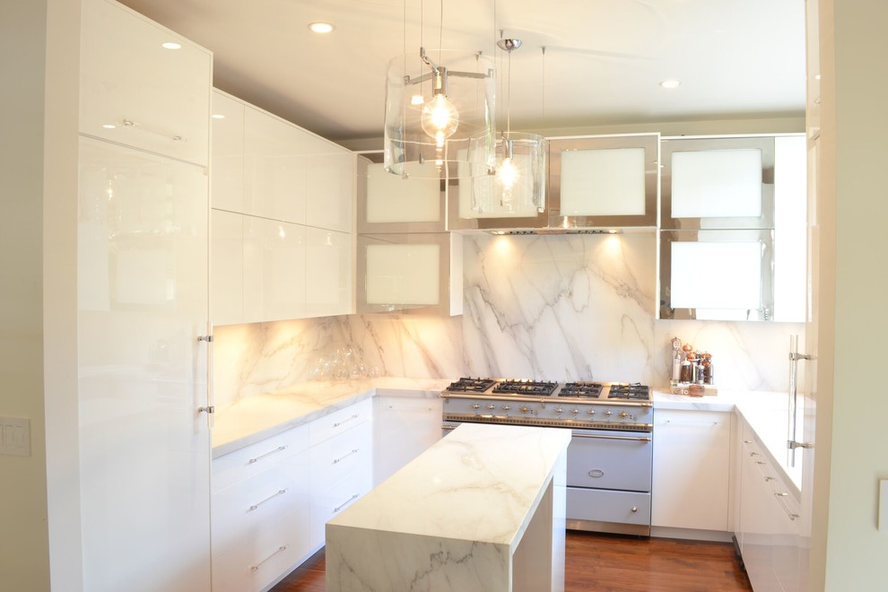 Mid-sized contemporary u-shaped eat-in kitchen in Chicago with a single-bowl sink, glass-front cabinets, white cabinets, marble benchtops, white splashback, marble splashback, panelled appliances, medium hardwood floors, with island and brown floor.