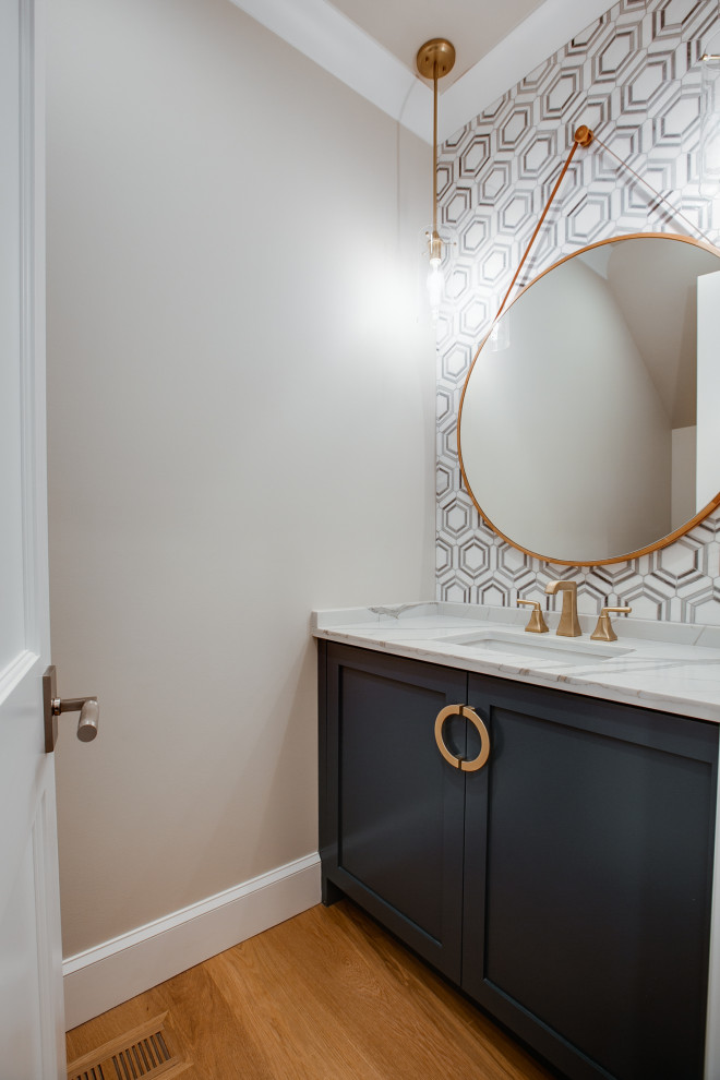 Medium sized classic cloakroom in Charlotte with shaker cabinets, blue cabinets, a two-piece toilet, black and white tiles, marble tiles, grey walls, medium hardwood flooring, a submerged sink, engineered stone worktops, yellow floors, white worktops and a built in vanity unit.