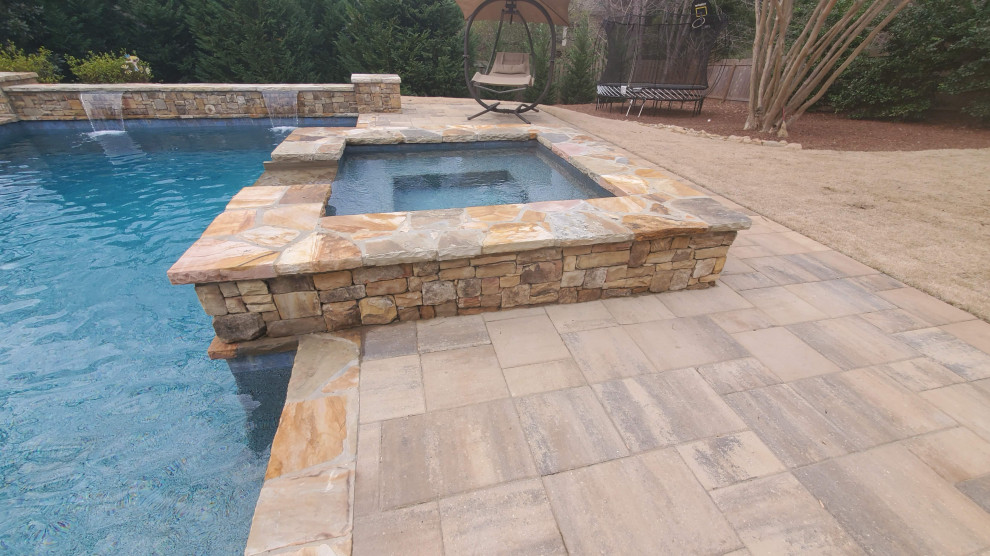 Photo of a mid-sized country backyard rectangular natural pool in Atlanta with a hot tub and concrete pavers.