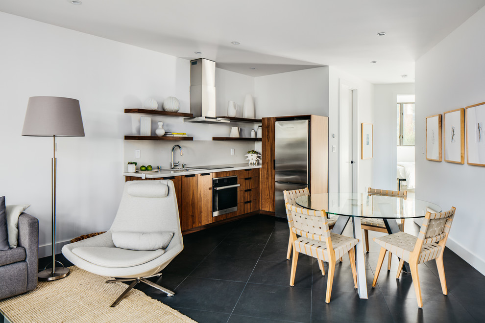 This is an example of a mid-sized modern single-wall eat-in kitchen in San Francisco with an undermount sink, open cabinets, dark wood cabinets, quartzite benchtops, white splashback, stone slab splashback, stainless steel appliances, ceramic floors, no island, black floor and white benchtop.