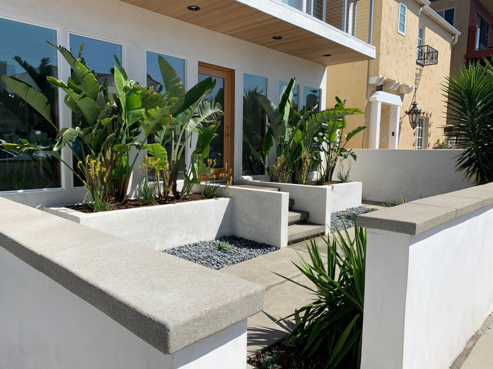 Foto de jardín moderno pequeño en patio delantero con privacidad, exposición total al sol, piedra decorativa y con madera