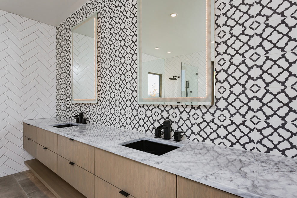 Inspiration for a large contemporary master bathroom in Albuquerque with flat-panel cabinets, medium wood cabinets, a freestanding tub, an open shower, black and white tile, cement tile, white walls, cement tiles, an undermount sink, marble benchtops, grey floor and an open shower.