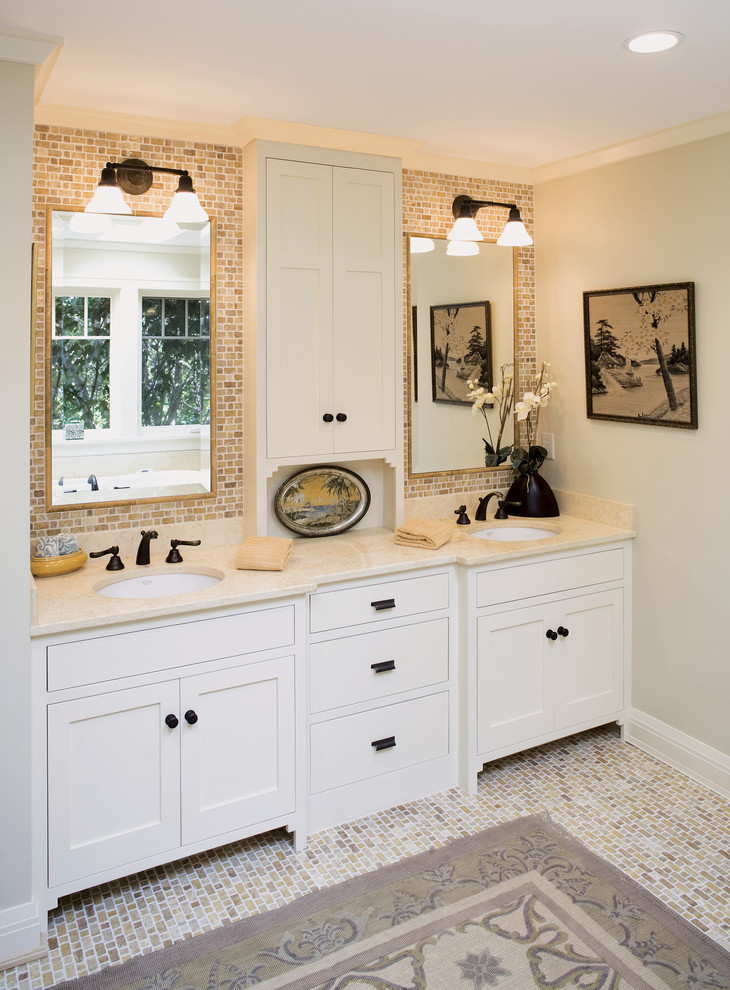 Photo of a traditional bathroom in Minneapolis with an undermount sink, white cabinets and shaker cabinets.