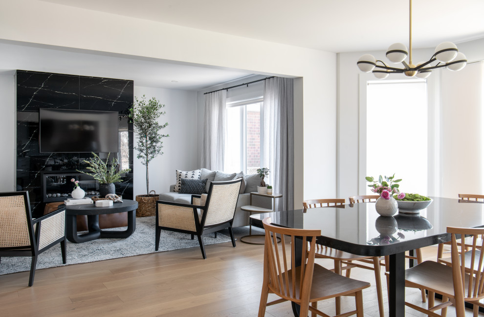 Example of a mid-sized transitional u-shaped light wood floor and brown floor eat-in kitchen design in Ottawa with an undermount sink, shaker cabinets, white cabinets, quartz countertops, white backsplash, quartz backsplash, stainless steel appliances, a peninsula and white countertops