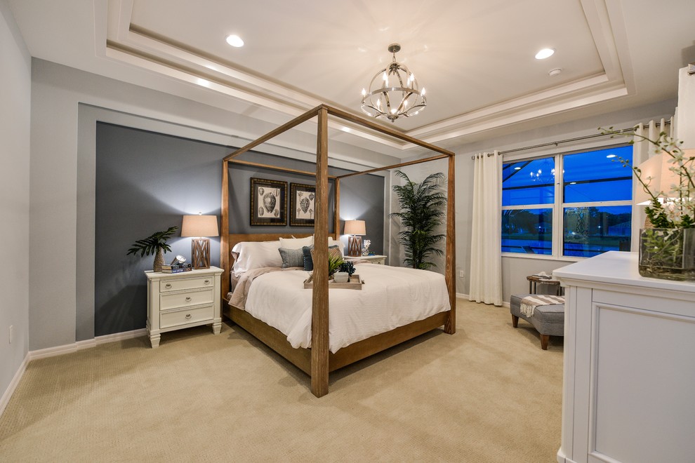 Inspiration for a mid-sized transitional master bedroom in Tampa with grey walls and carpet.