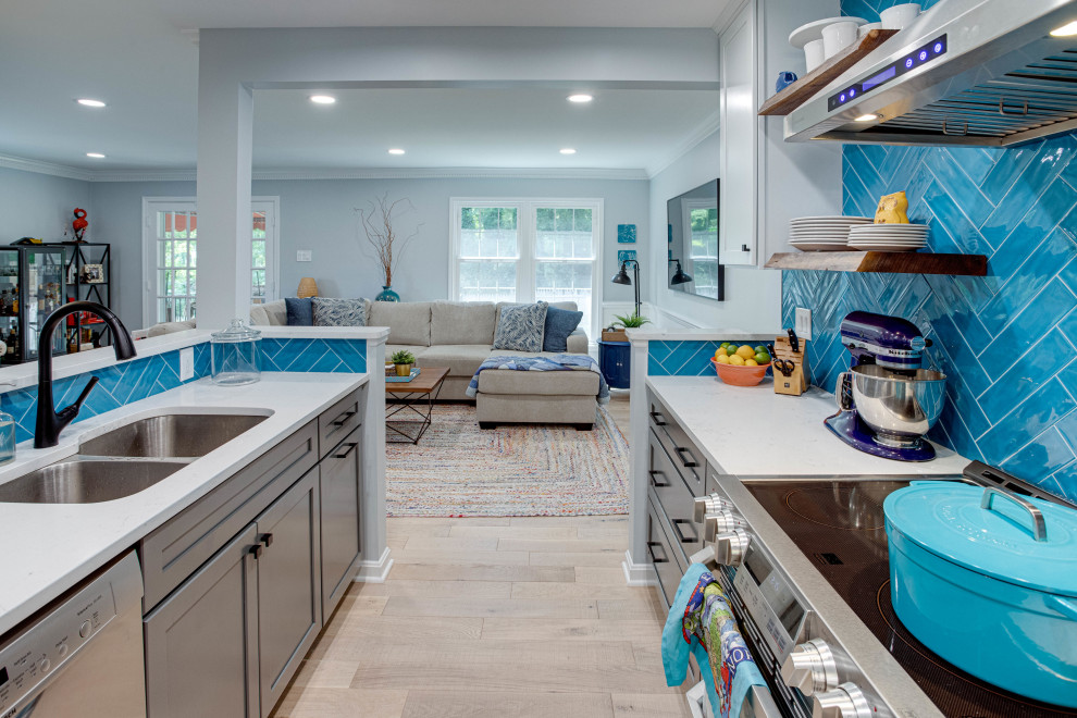Inspiration for a mid-sized transitional galley kitchen remodel in DC Metro with an undermount sink, shaker cabinets, quartz countertops, blue backsplash, stainless steel appliances and no island