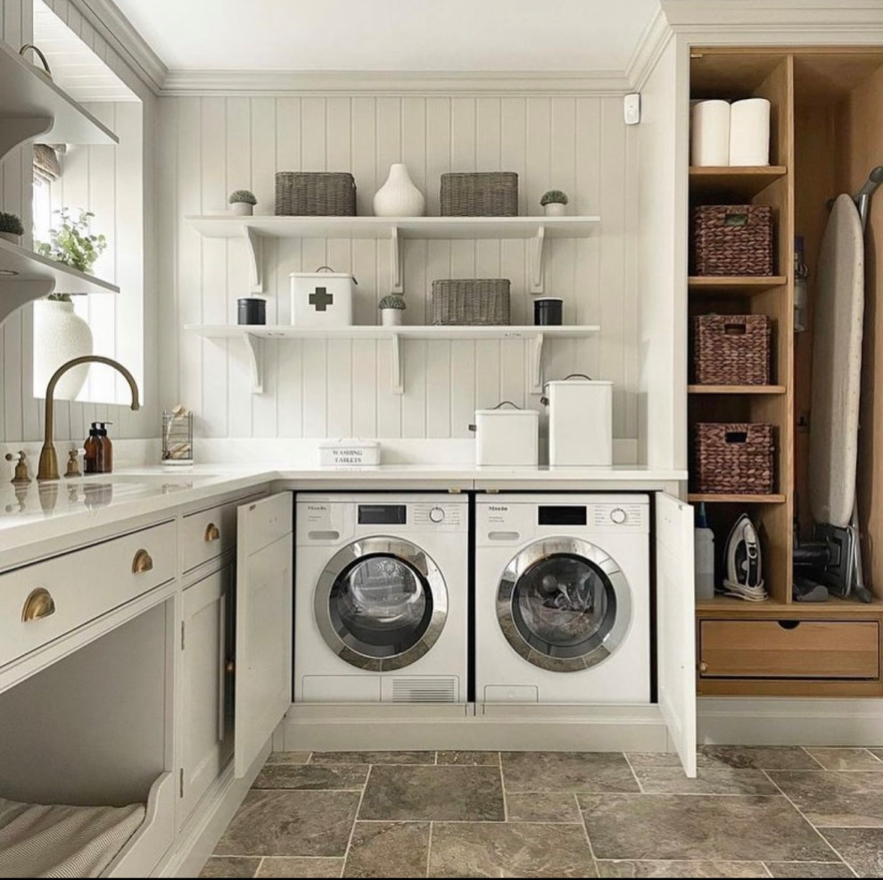 This is an example of a mid-sized l-shaped dedicated laundry room in Dallas with an undermount sink, shaker cabinets, white cabinets, quartz benchtops, white splashback, timber splashback, white walls, porcelain floors, a side-by-side washer and dryer, brown floor, white benchtop and panelled walls.