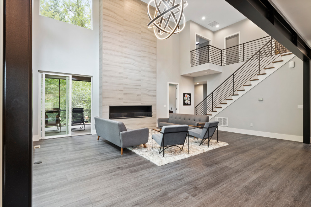 Large minimalist formal and open concept vinyl floor, gray floor and vaulted ceiling living room photo in Seattle with gray walls, a standard fireplace and a stone fireplace