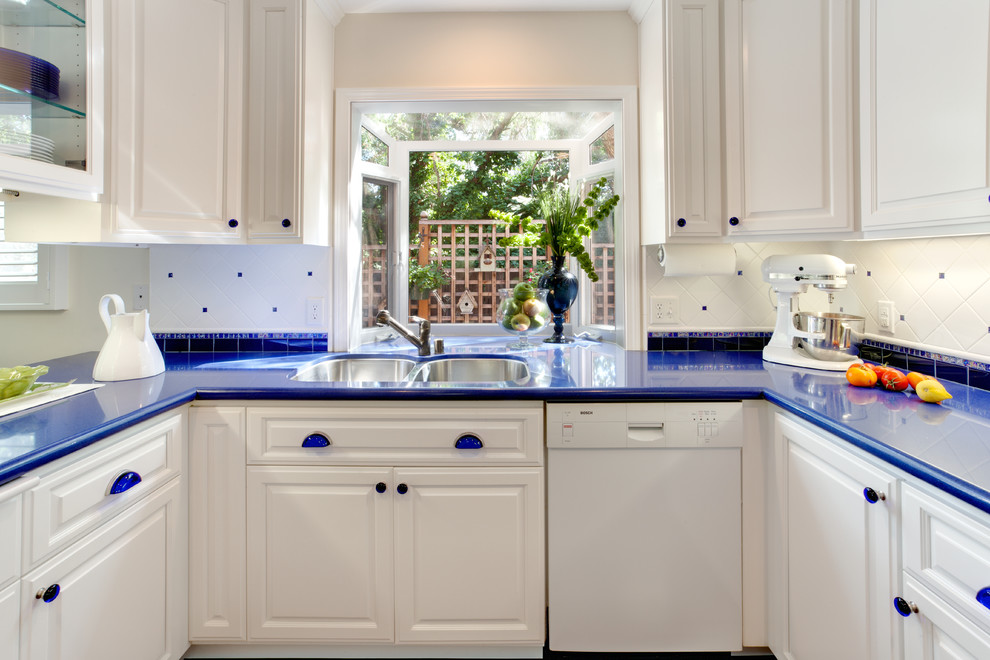 This is an example of a traditional kitchen in San Francisco with white appliances, a double-bowl sink and blue benchtop.