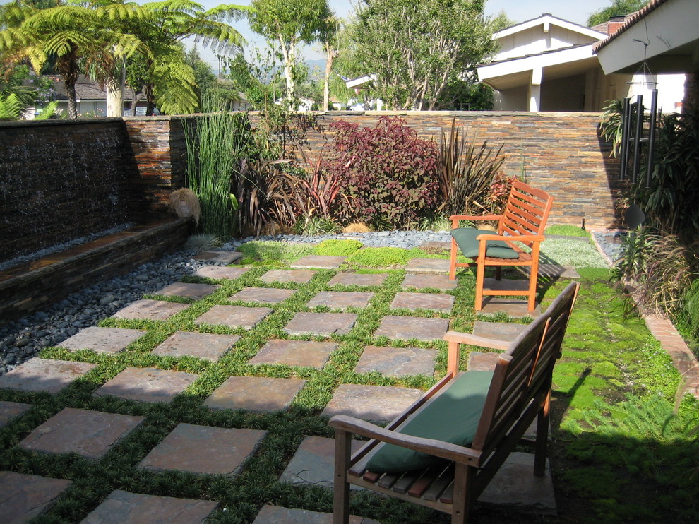 Photo of a small asian backyard full sun formal garden in Orange County with a water feature and natural stone pavers.