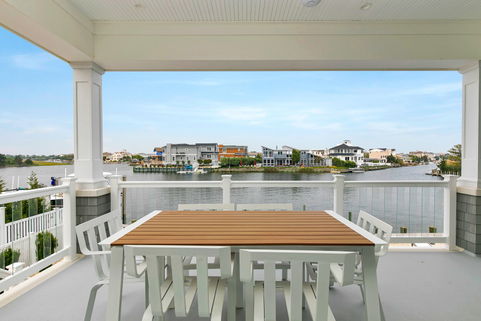 Example of a large beach style balcony design in Tampa