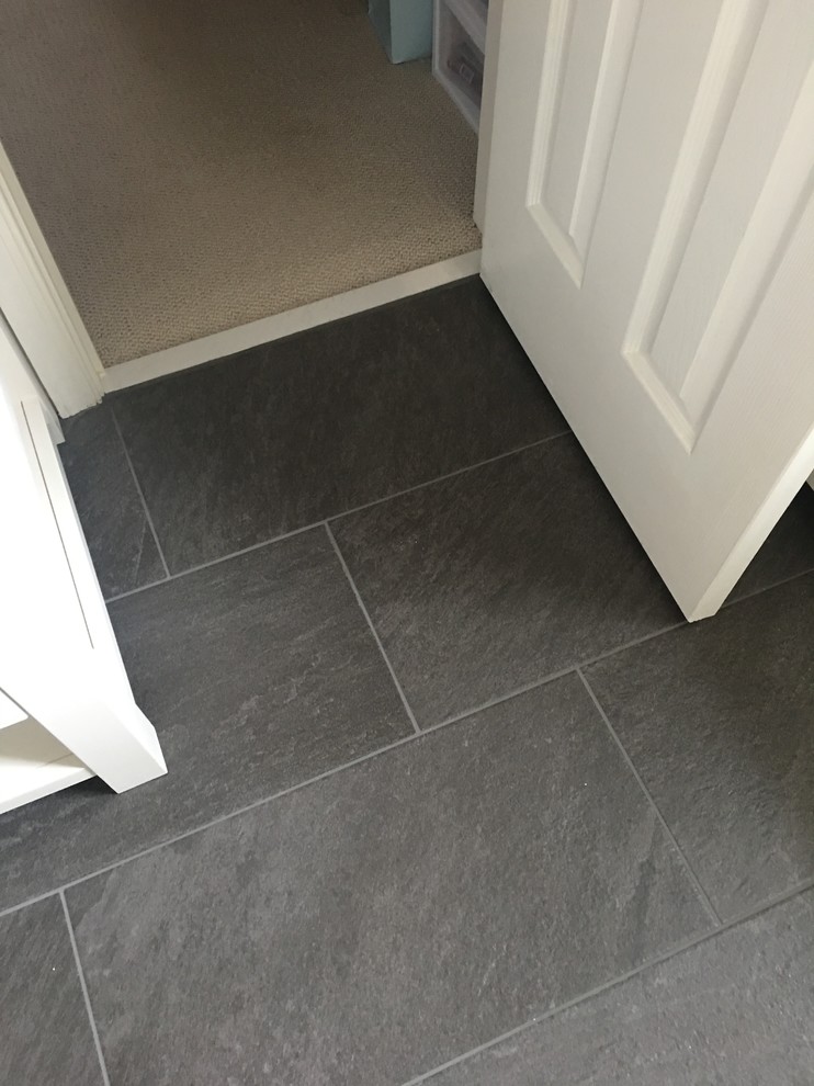 Inspiration for a mid-sized timeless 3/4 porcelain tile and white tile porcelain tile and black floor alcove bathtub remodel with shaker cabinets, white cabinets, white walls, an undermount sink, marble countertops and a two-piece toilet