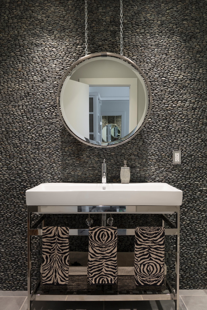Inspiration for a contemporary powder room in New York with a console sink, gray tile and pebble tile.