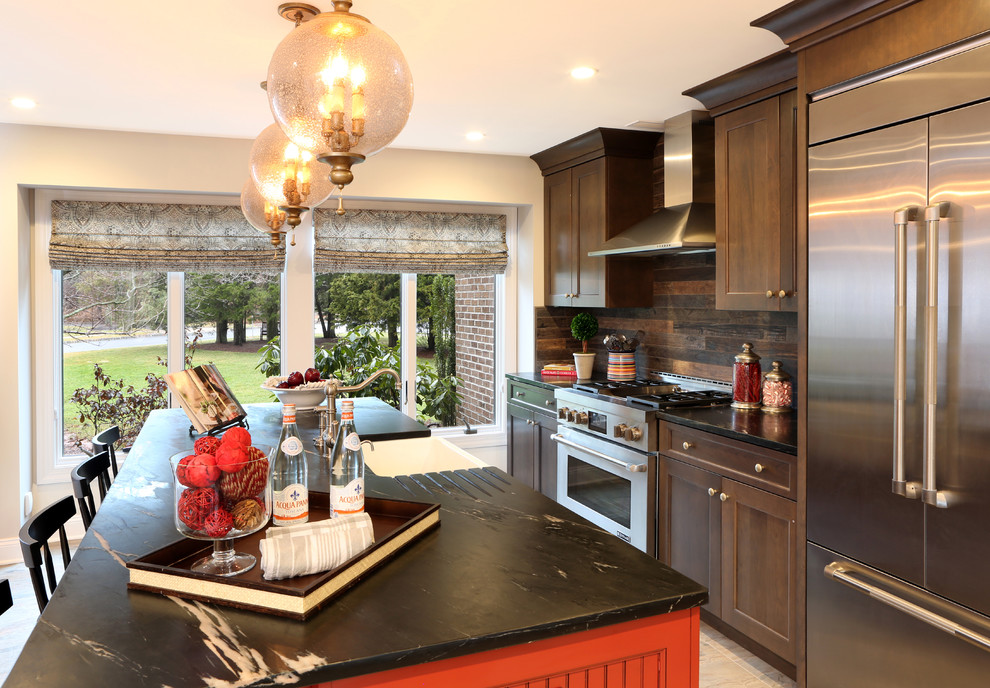 Eat-in kitchen - large traditional single-wall porcelain tile eat-in kitchen idea in New York with a farmhouse sink, recessed-panel cabinets, dark wood cabinets, soapstone countertops, brown backsplash, porcelain backsplash, stainless steel appliances and an island