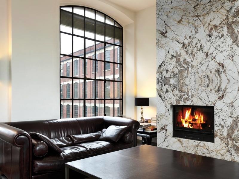 This is an example of an industrial living room in Boise with white walls, a standard fireplace and a stone fireplace surround.