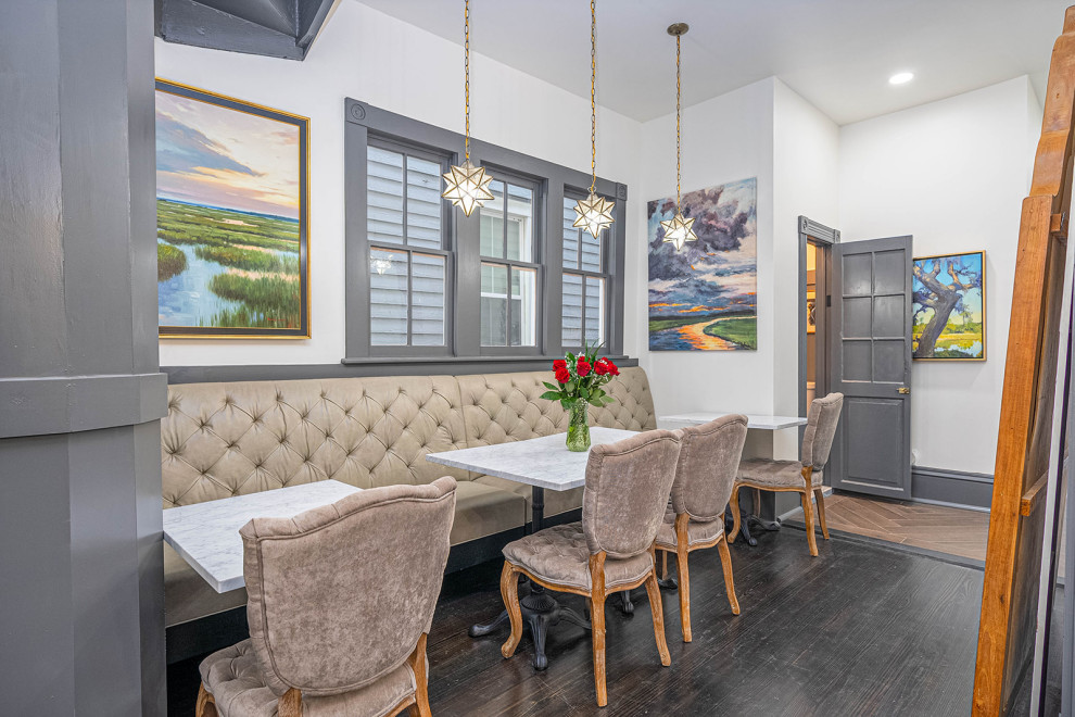 Example of a mid-sized transitional dark wood floor and black floor kitchen/dining room combo design with white walls