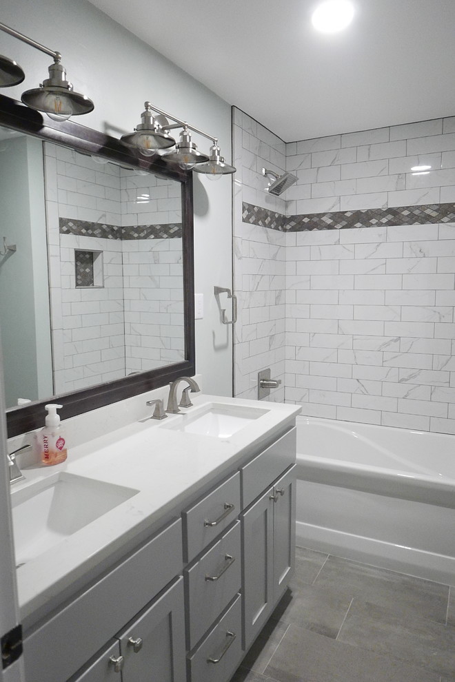 Mid-sized transitional kids' white tile and porcelain tile porcelain tile and gray floor alcove bathtub photo with shaker cabinets, gray cabinets, a two-piece toilet, green walls, an undermount sink, quartz countertops and white countertops