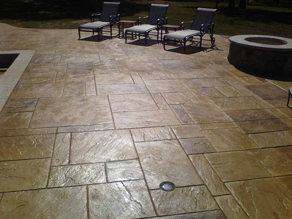 This is an example of a mid-sized traditional backyard patio in Dallas with stamped concrete.