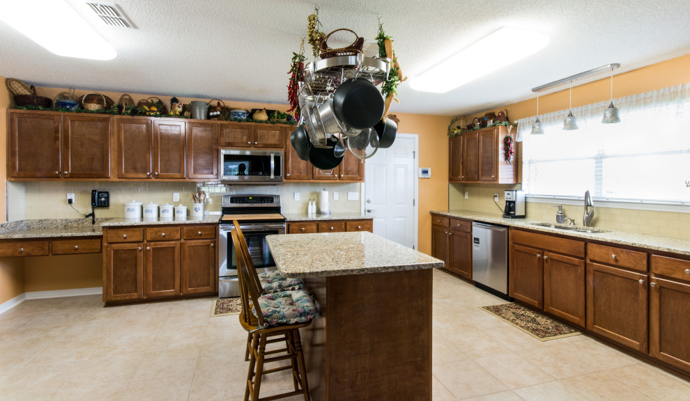 Large l-shaped ceramic tile and beige floor eat-in kitchen photo with an undermount sink, flat-panel cabinets, brown cabinets and an island
