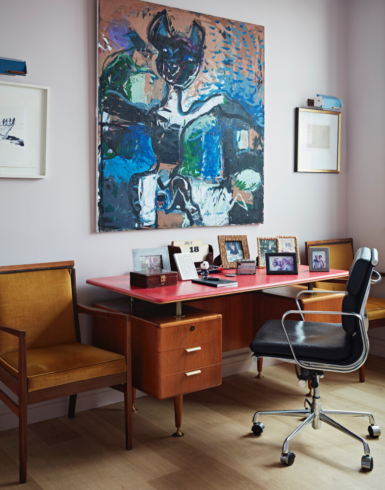 Inspiration for a mid-sized eclectic home office in London with pink walls, light hardwood floors, a freestanding desk and beige floor.
