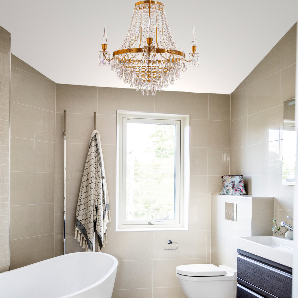 Inspiration for a mid-sized traditional master bathroom in Stockholm with flat-panel cabinets, a freestanding tub, a wall-mount toilet, beige tile, ceramic tile and beige walls.