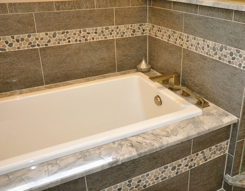 Inspiration for a mid-sized transitional master gray tile and porcelain tile porcelain tile drop-in bathtub remodel in Cincinnati with granite countertops and beige walls