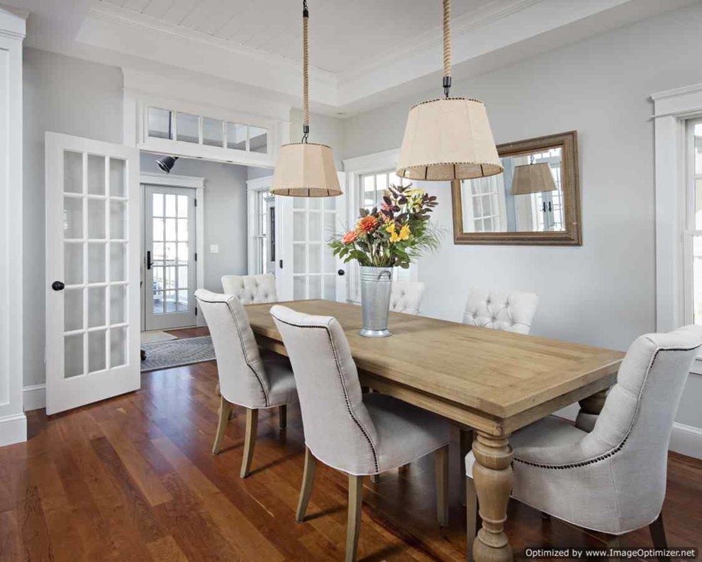 Photo of a large beach style open plan dining in New York with white walls and medium hardwood floors.