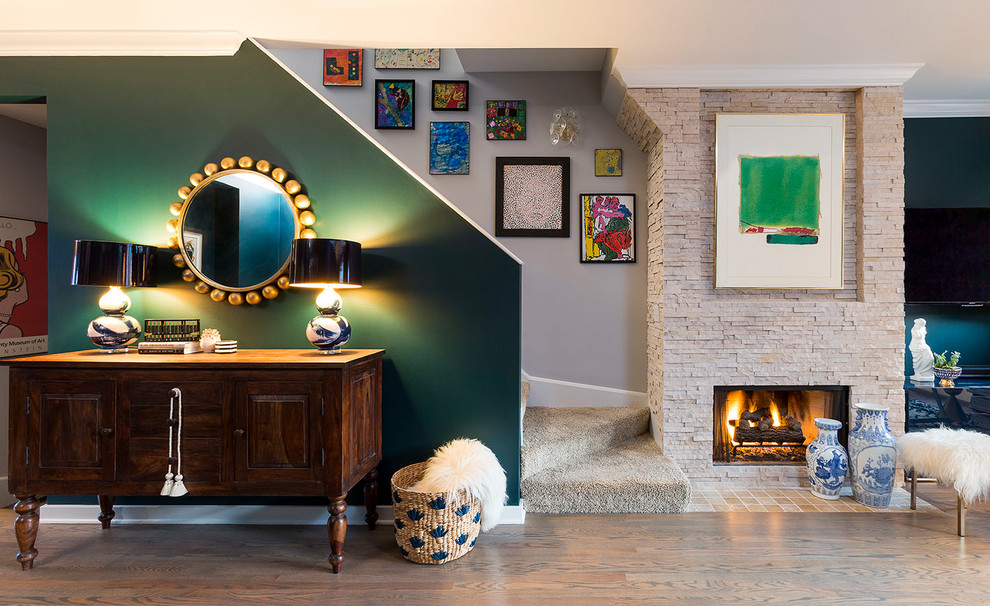 Living room - mid-sized eclectic open concept dark wood floor living room idea in Chicago with green walls, a standard fireplace, a stone fireplace and a wall-mounted tv
