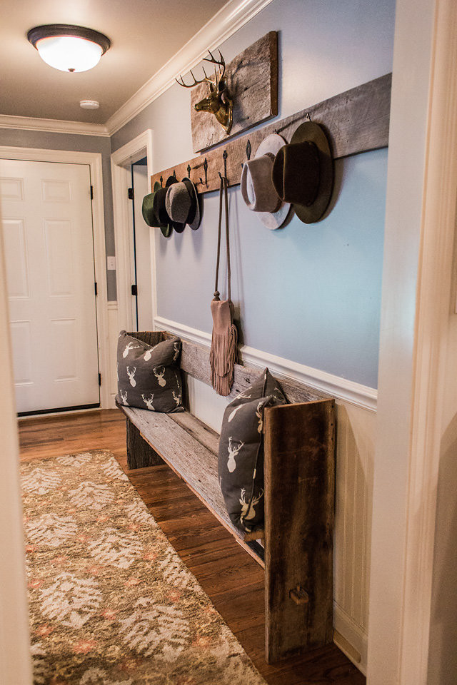 Inspiration for a transitional medium tone wood floor and brown floor hallway remodel with blue walls
