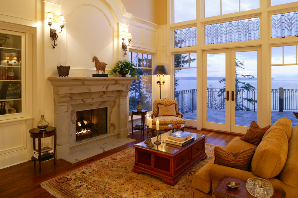 Photo of a large traditional formal enclosed living room in Vancouver with beige walls, medium hardwood floors, a standard fireplace, a stone fireplace surround and no tv.