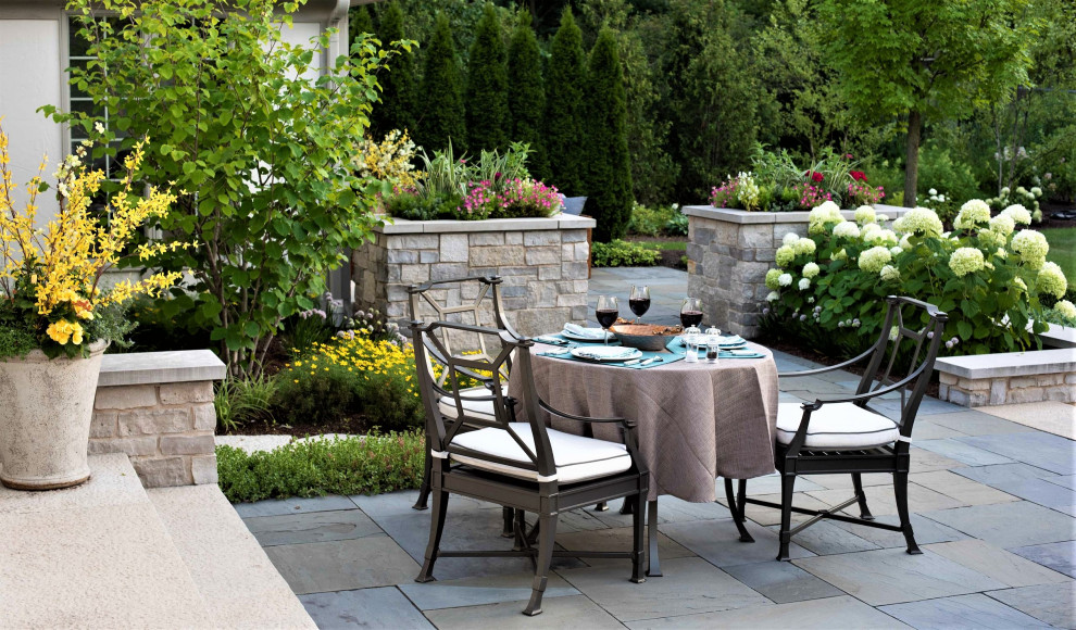 Inspiration for a traditional backyard patio in Chicago with natural stone pavers and no cover.