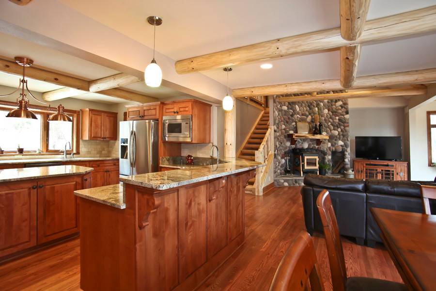Large mountain style u-shaped medium tone wood floor eat-in kitchen photo in Milwaukee with a single-bowl sink, shaker cabinets, medium tone wood cabinets, granite countertops, beige backsplash, ceramic backsplash, stainless steel appliances and an island